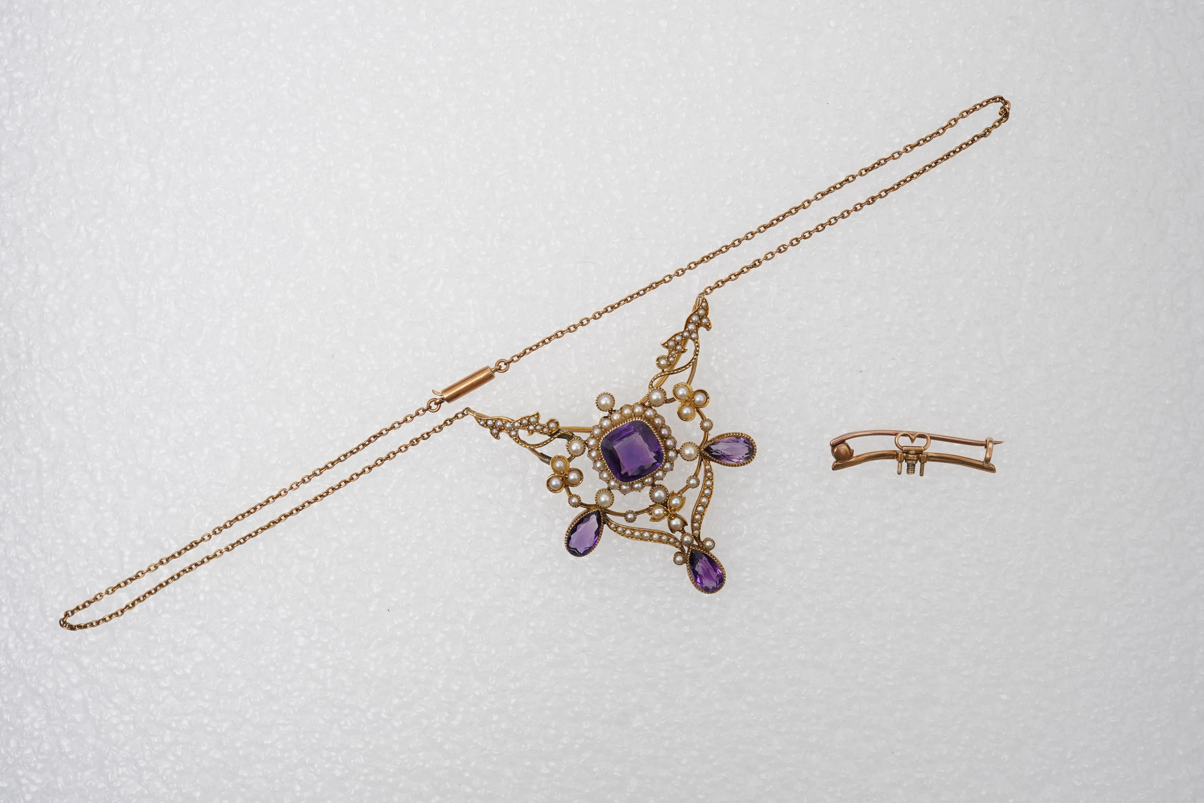 An Edwardian seed pearl and amethyst pendant/brooch, early 20th century